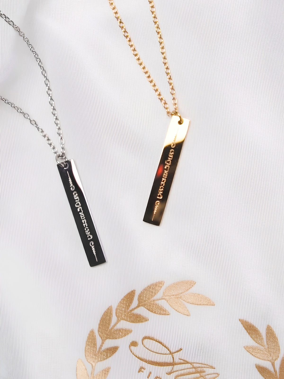 Gold and silver Nak Muay Ying Muay Thai bar necklaces side by side
