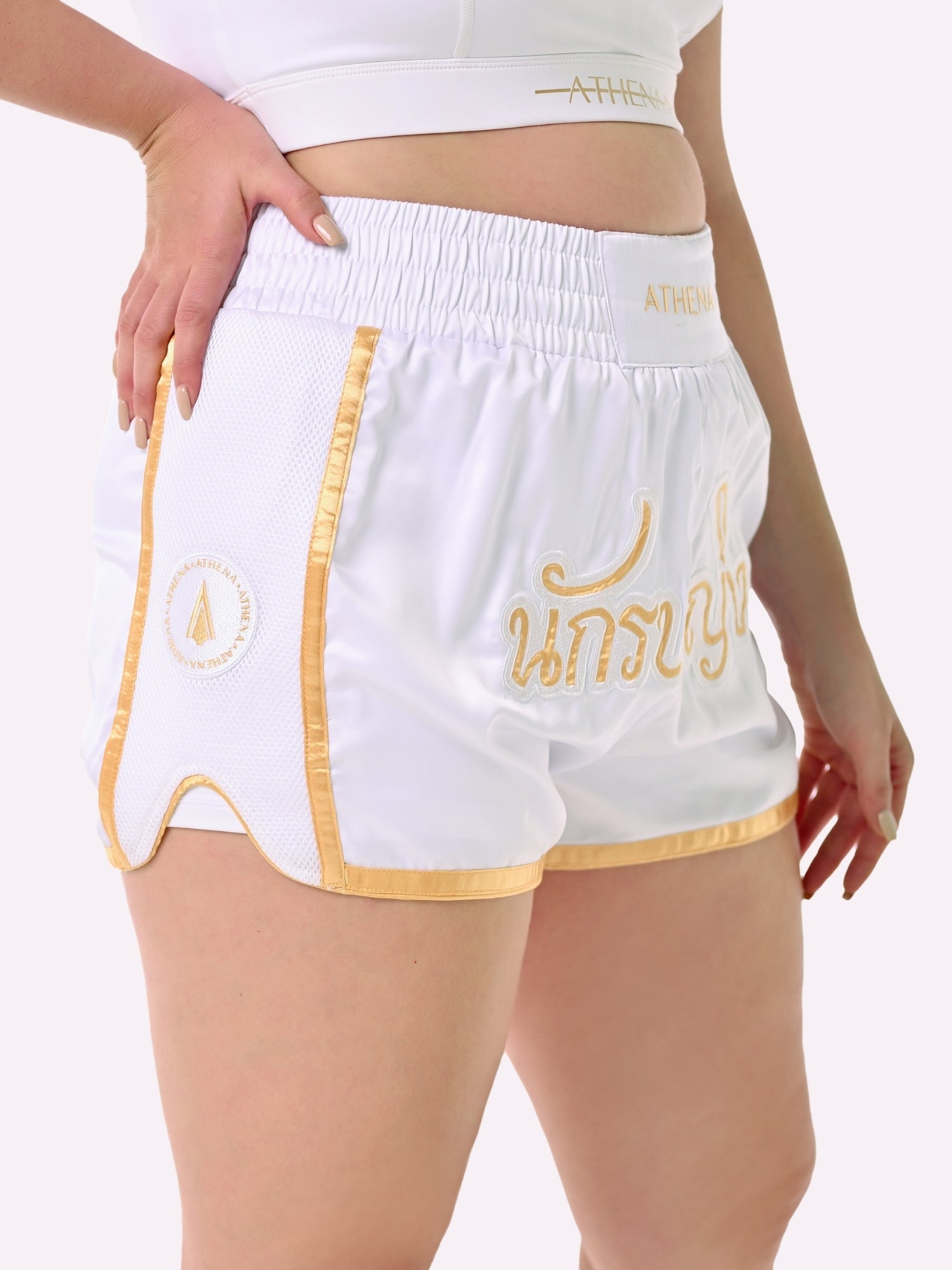 Athena Fightwear Artemisia women's white and gold muay thai shorts with wide hips and anti-camel toe built-in safety compression shorts