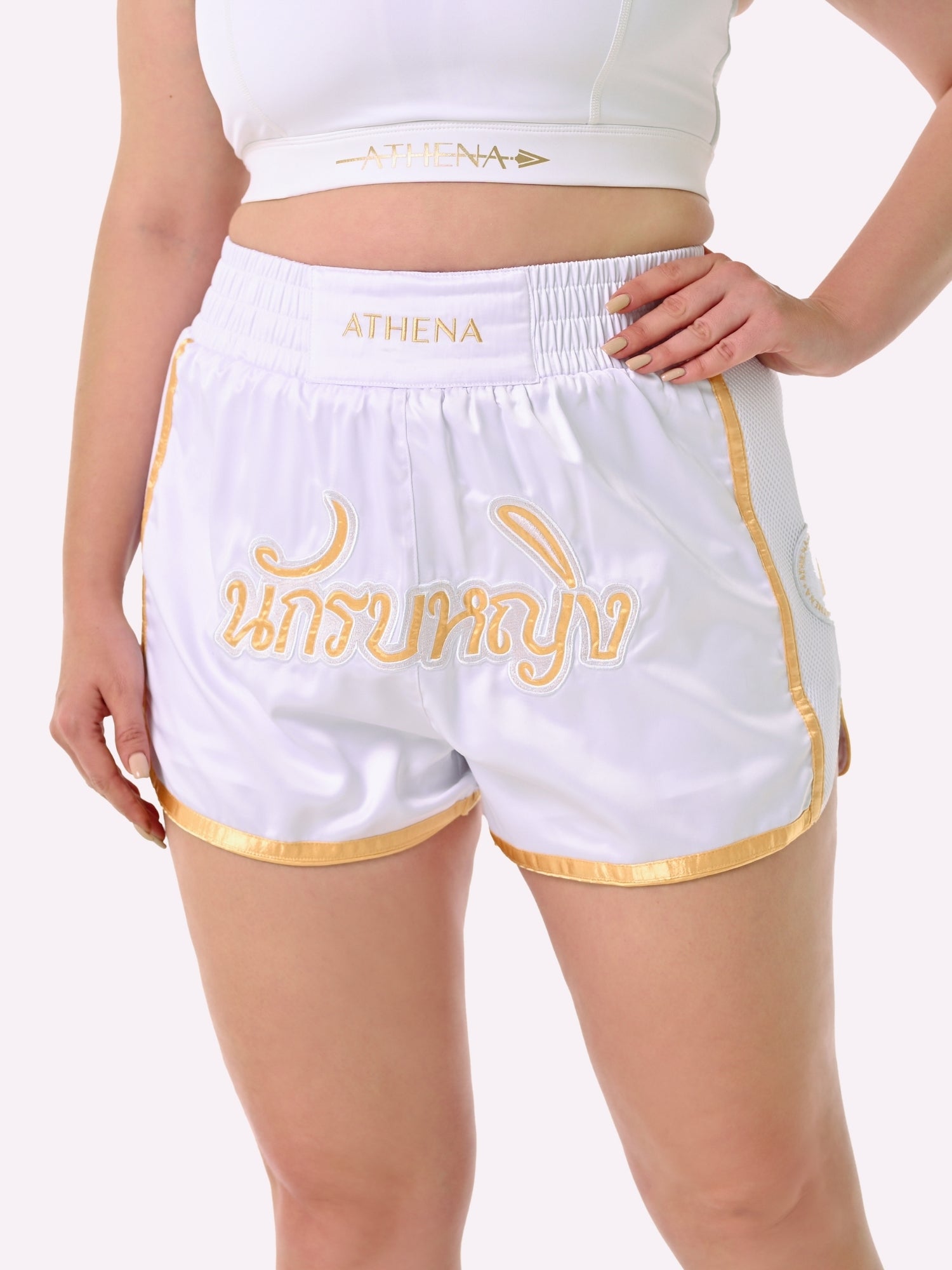 Athena Fightwear Artemisia women's white and gold muay thai shorts with wide hips and anti-camel toe built-in safety compression shorts
