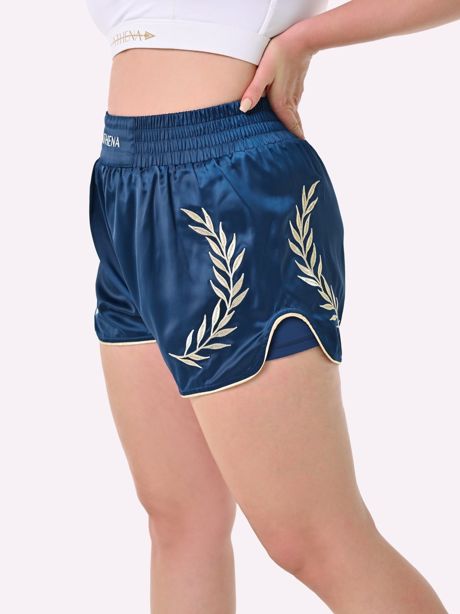 Athena Fightwear Athena Women's Muay Thai Shorts navy blue and gold with wide hips made for the female body with built-in compression safety shorts with anti-camel toe and anti-ride up design and pockets