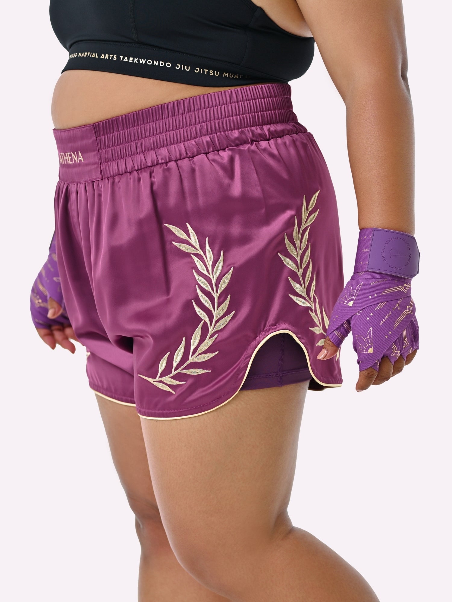 Athena Fightwear Athena Women's Muay Thai Shorts plum purple and gold made with female waist to hip ratio wide hips built-in safety shorts with anti-camel toe and anti-ride up design and pockets