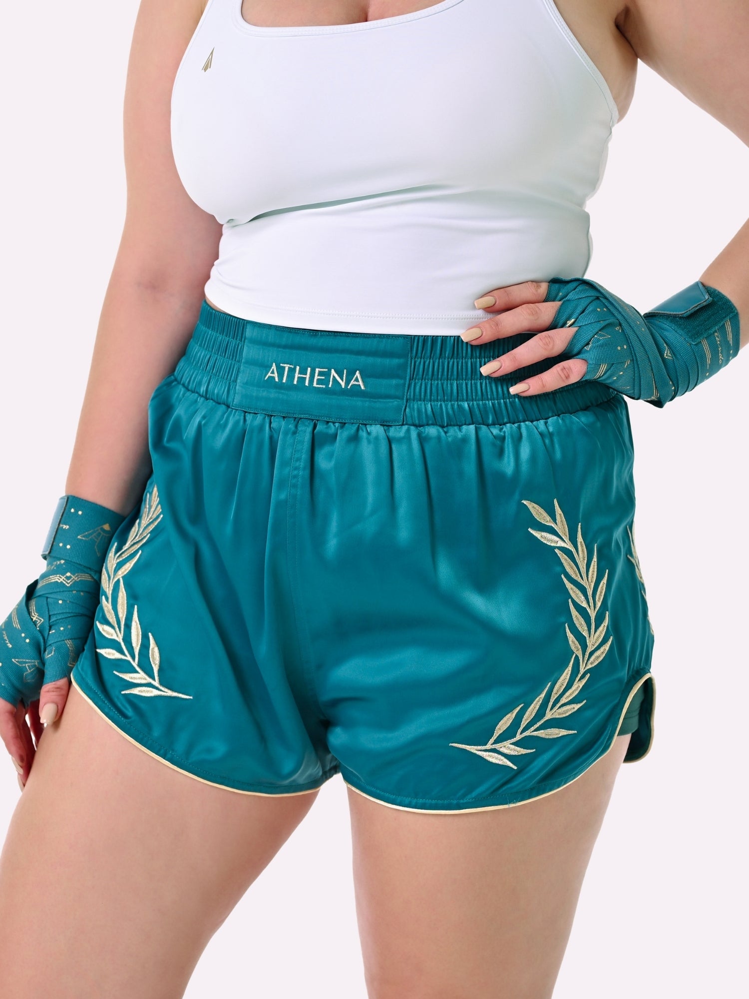Athena Fightwear Athena Women's Muay Thai Shorts teal & gold made with female waist to hip ratio wide hips built-in safety shorts with anti-camel toe and anti-ride up design and pockets