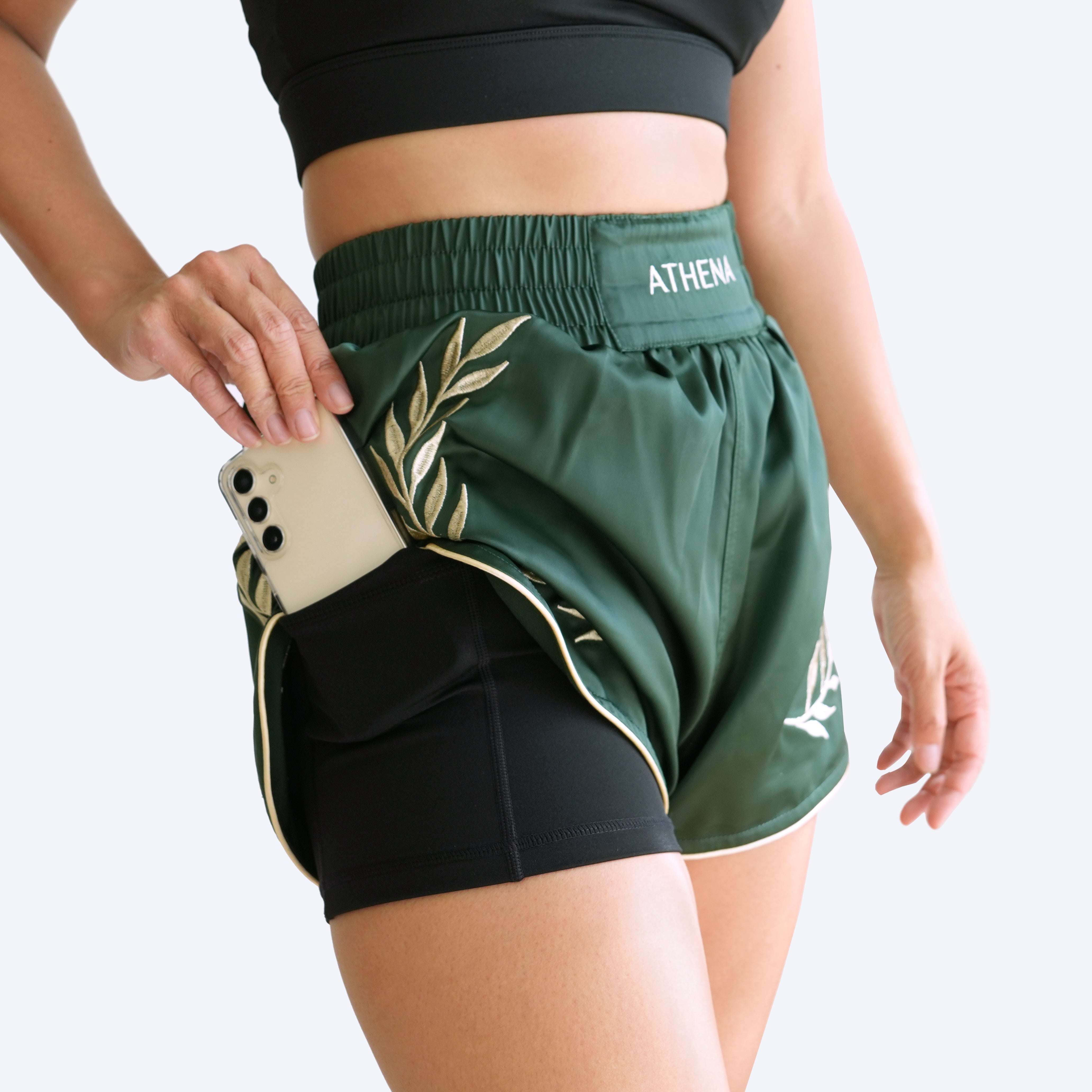 Athena Fightwear women's muay thai shorts dark green with wide hips and built-in safety shorts with anti camel toe and pockets