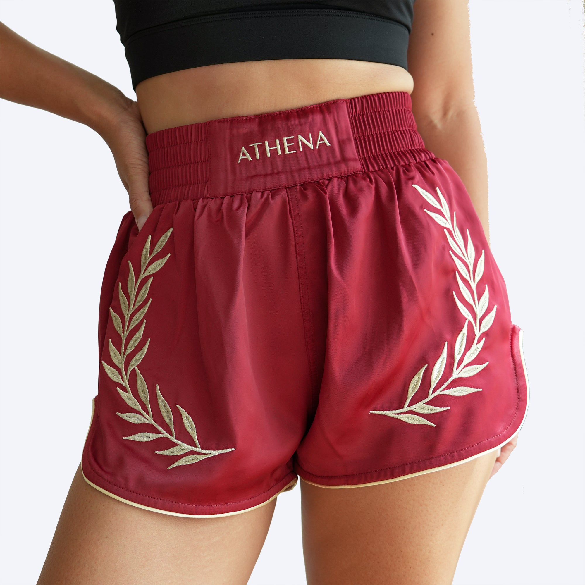 Athena Fightwear women's muay thai shorts crimson red gold with wide hips and built in safety shorts with anti camel toe anti ride up and pockets