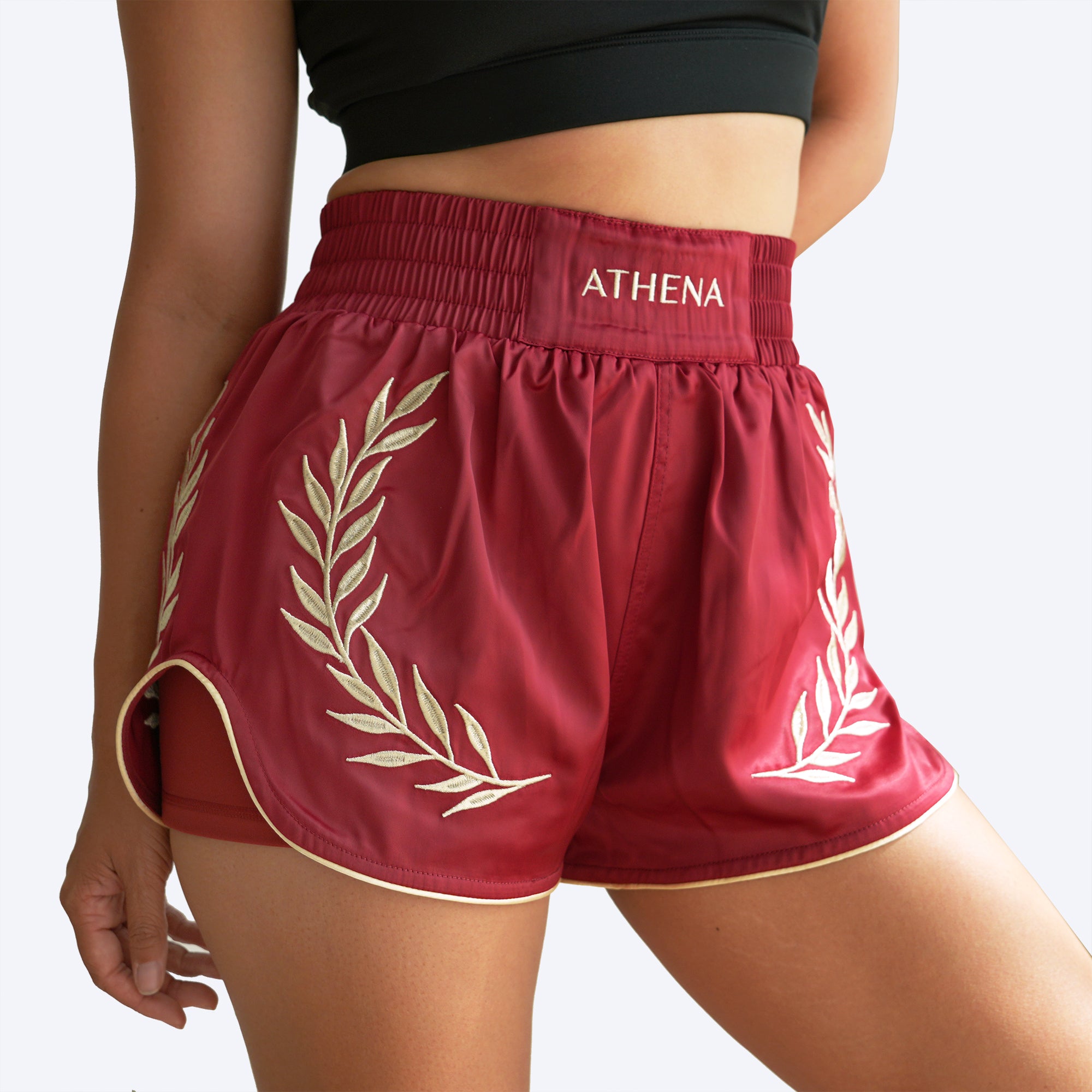 Athena Fightwear women's muay thai shorts crimson red gold with wide hips and built in safety shorts with anti camel toe anti ride up and pockets