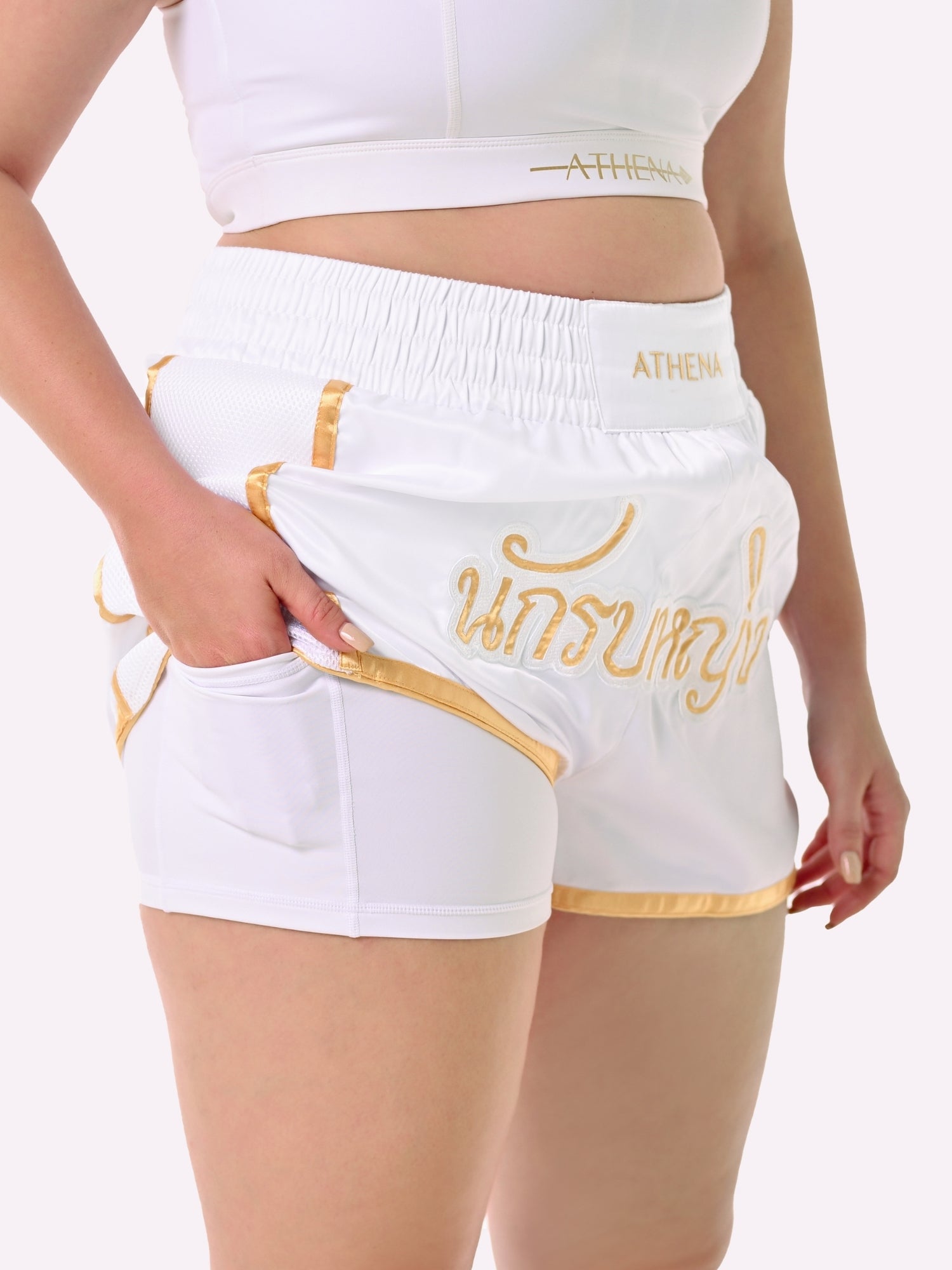 Athena Fightwear Artemisia women's white and gold muay thai shorts with wide hips and anti-camel toe built-in safety compression shorts