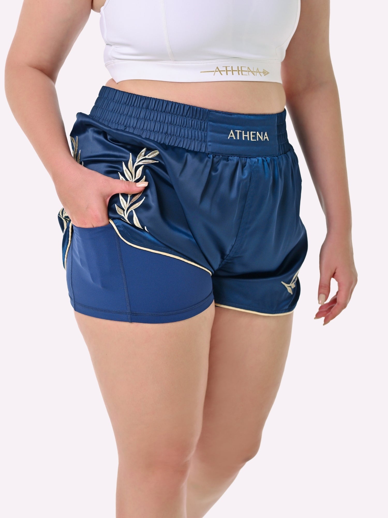 Athena Fightwear Athena Women's Muay Thai Shorts navy blue and gold with wide hips made for the female body with built-in compression safety shorts with anti-camel toe and anti-ride up design and pockets