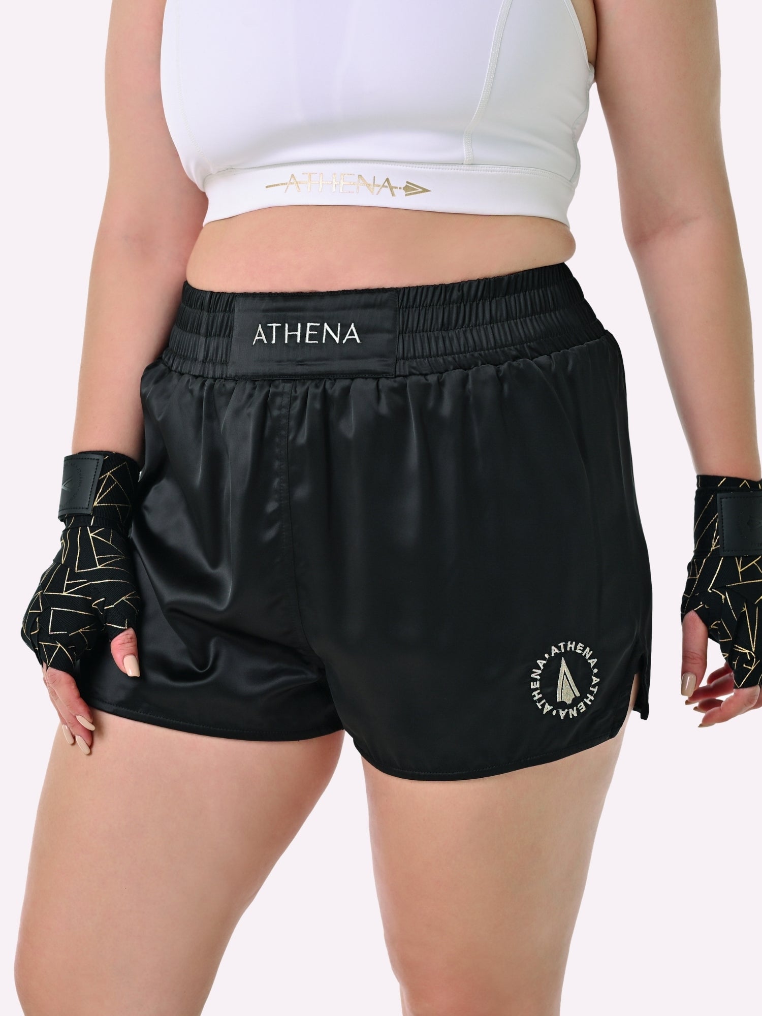 Athena Fightwear Enyo Muay Thai Shorts for women made for the female body black gold with wide hips built-in compression safety shorts with anti camel toe and anti ride up plus pockets