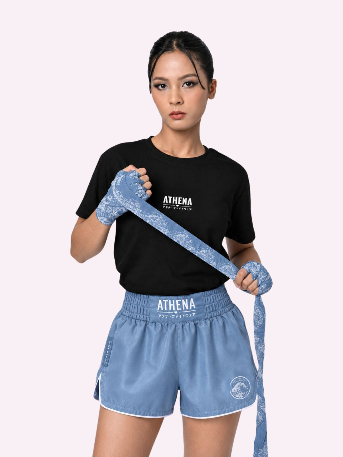 Woman wrapping her hands in Ryoko ash blue handwraps with Ryoko ash blue shorts
