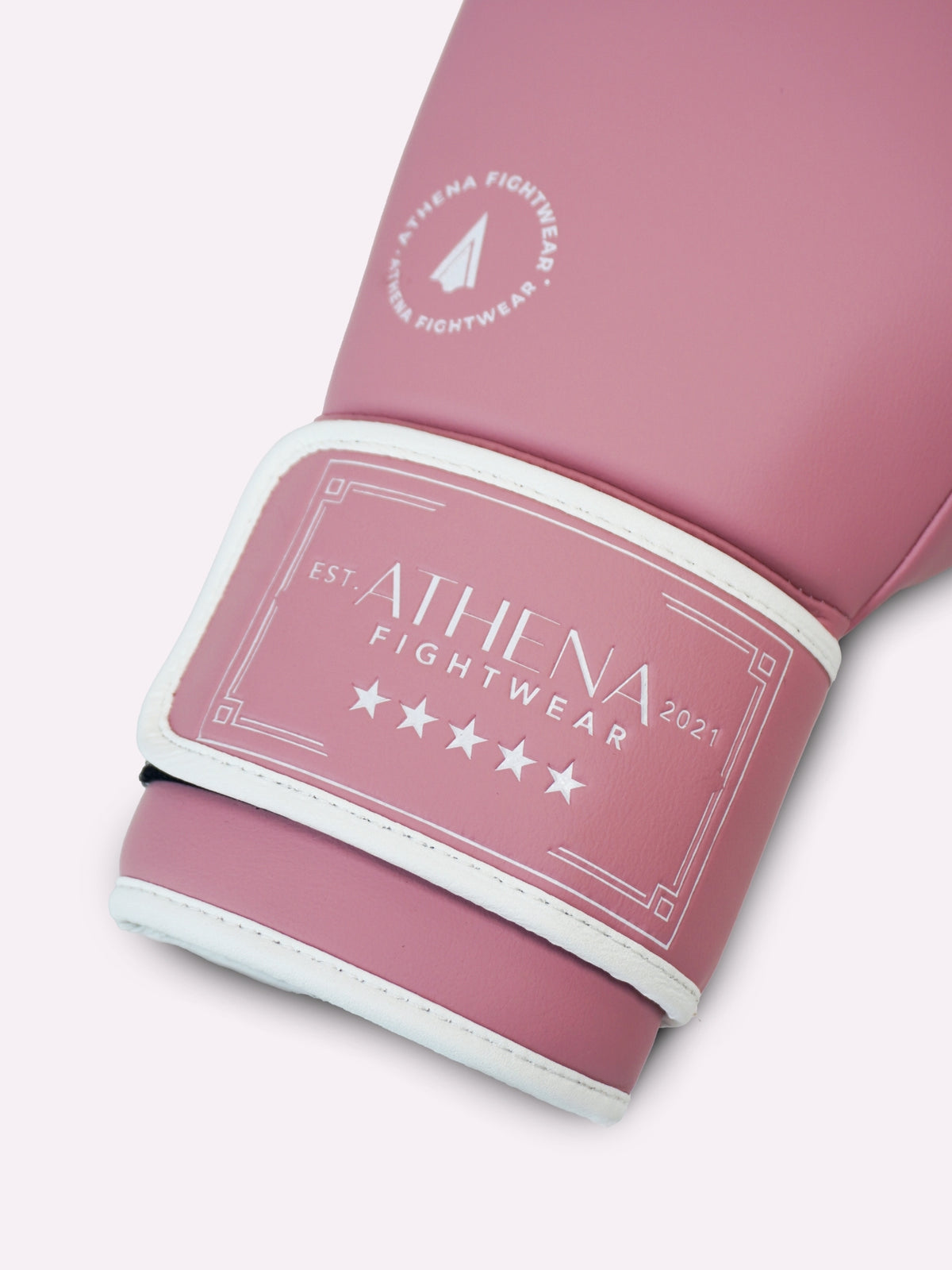 Close-up of the Athena logo on the long padded wrist strap of the orchid pink boxing glove