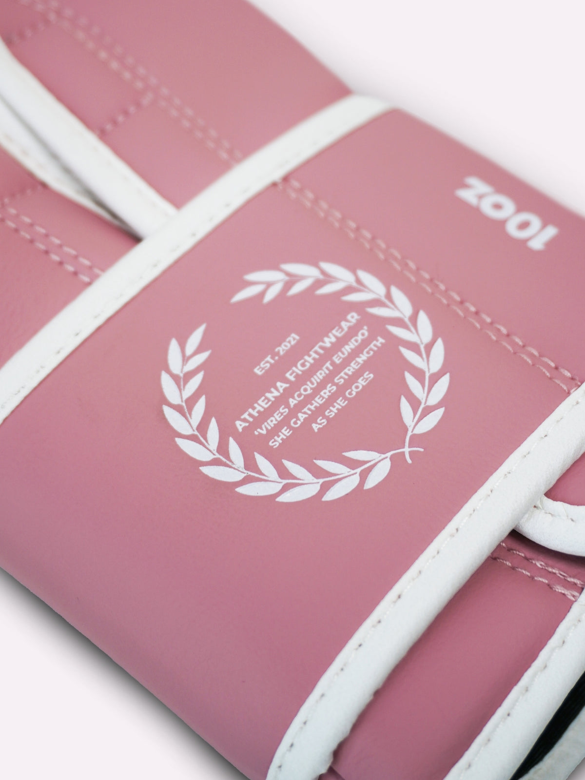 Close-up of the 10oz marking and laurel emblem on the orchid pink Athena glove wrist strap