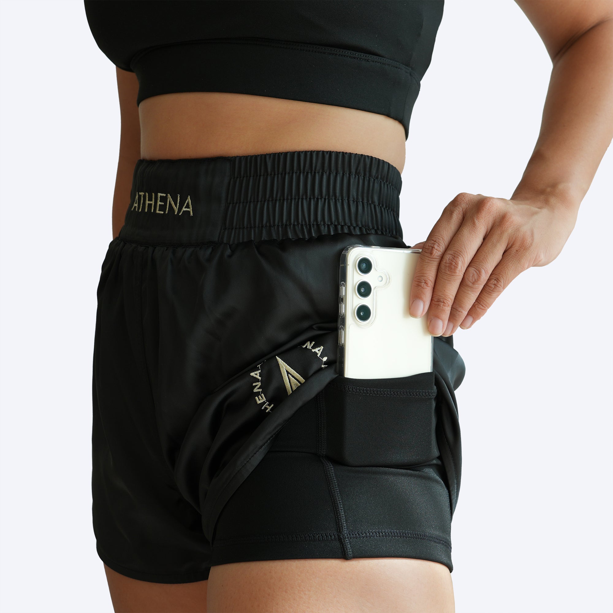 Athena Fightwear Enyo women's muay thai shorts black gold with wide hips and built in safety shorts with anti camel toe anti ride up and pockets
