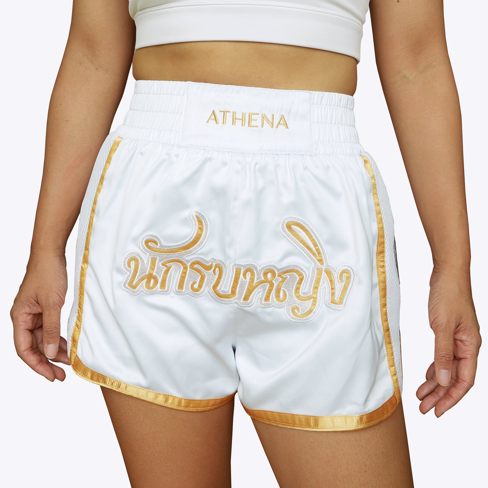 Athena Fightwear women's white and gold muay thai shorts with wide hips and anti-camel toe built-in safety compression shorts