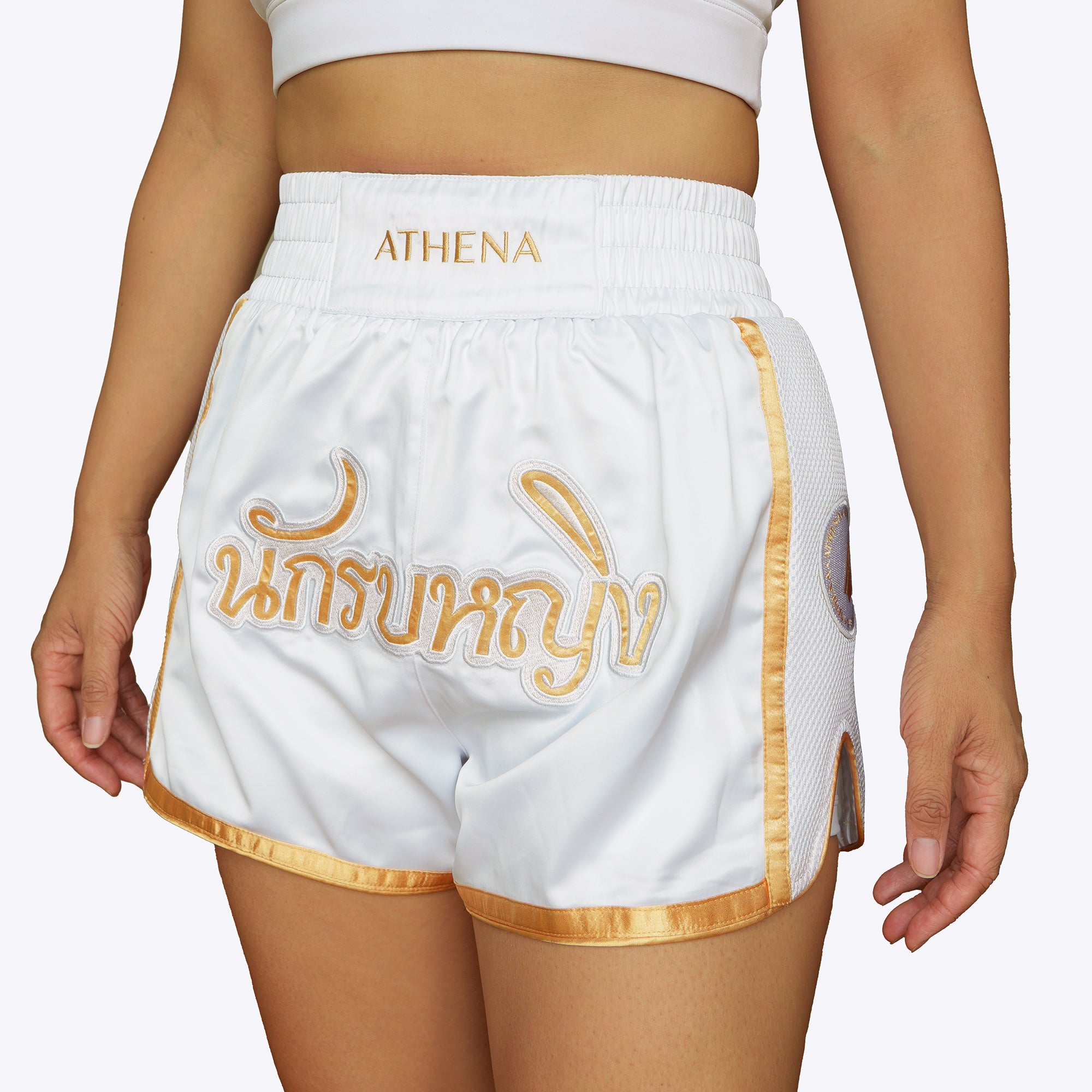 Athena Fightwear women's white and gold muay thai shorts with wide hips and anti-camel toe built-in safety compression shorts