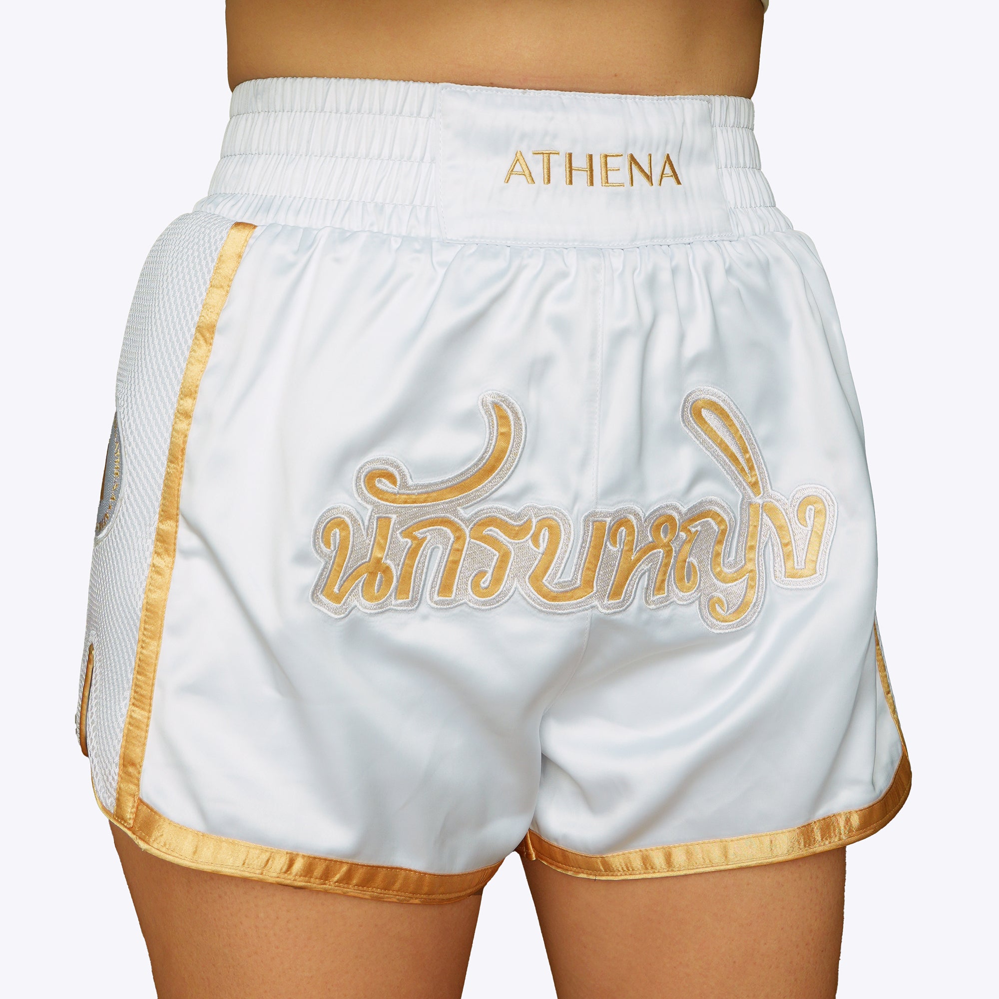 Athena Fightwear women's white and gold muay thai shorts with wide hips and anti-camel toe built-in safety compression shorts