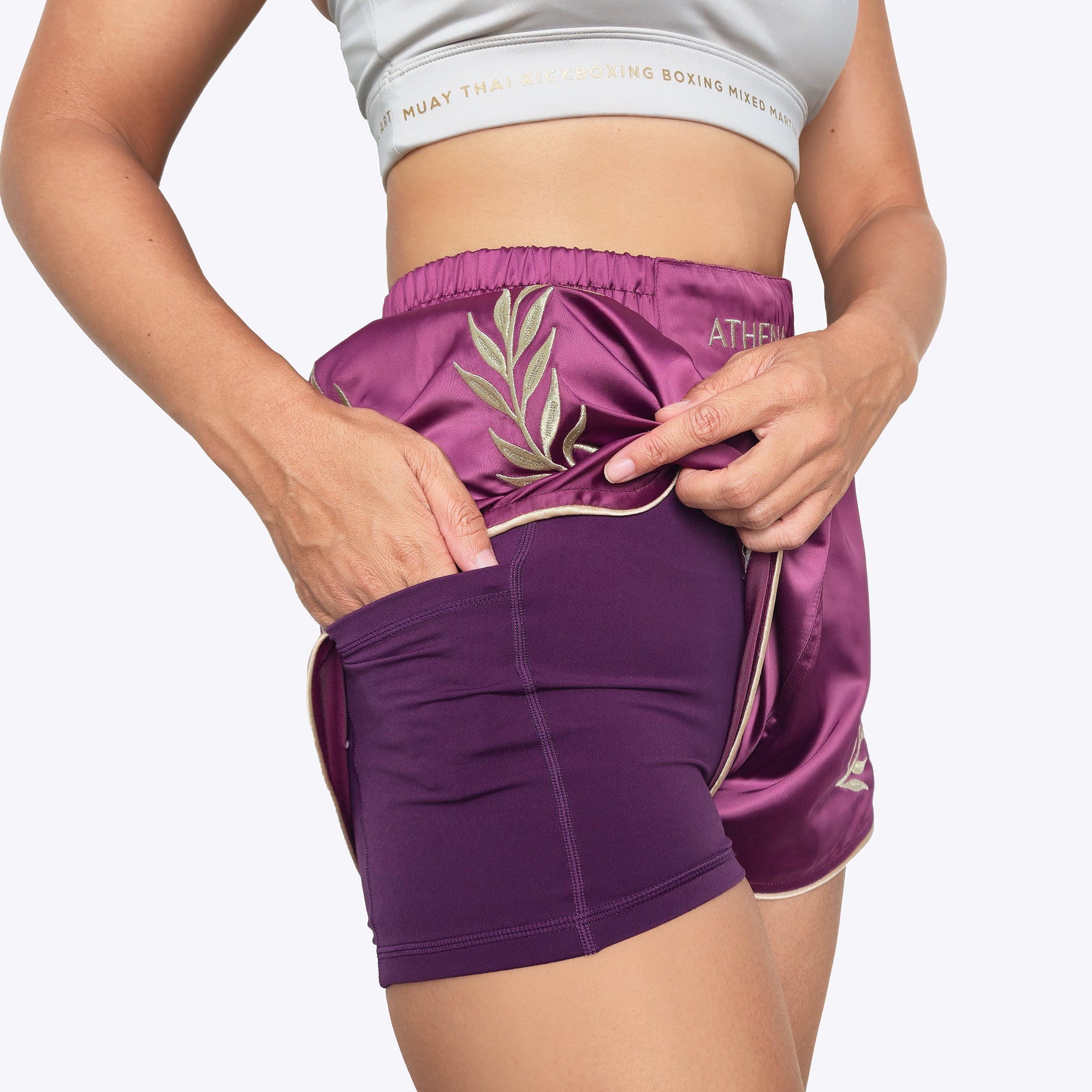 Athena Fightwear women's muay thai shorts with extra wide hips anti camel toe and pockets built in safety shorts plum purple violet and gold