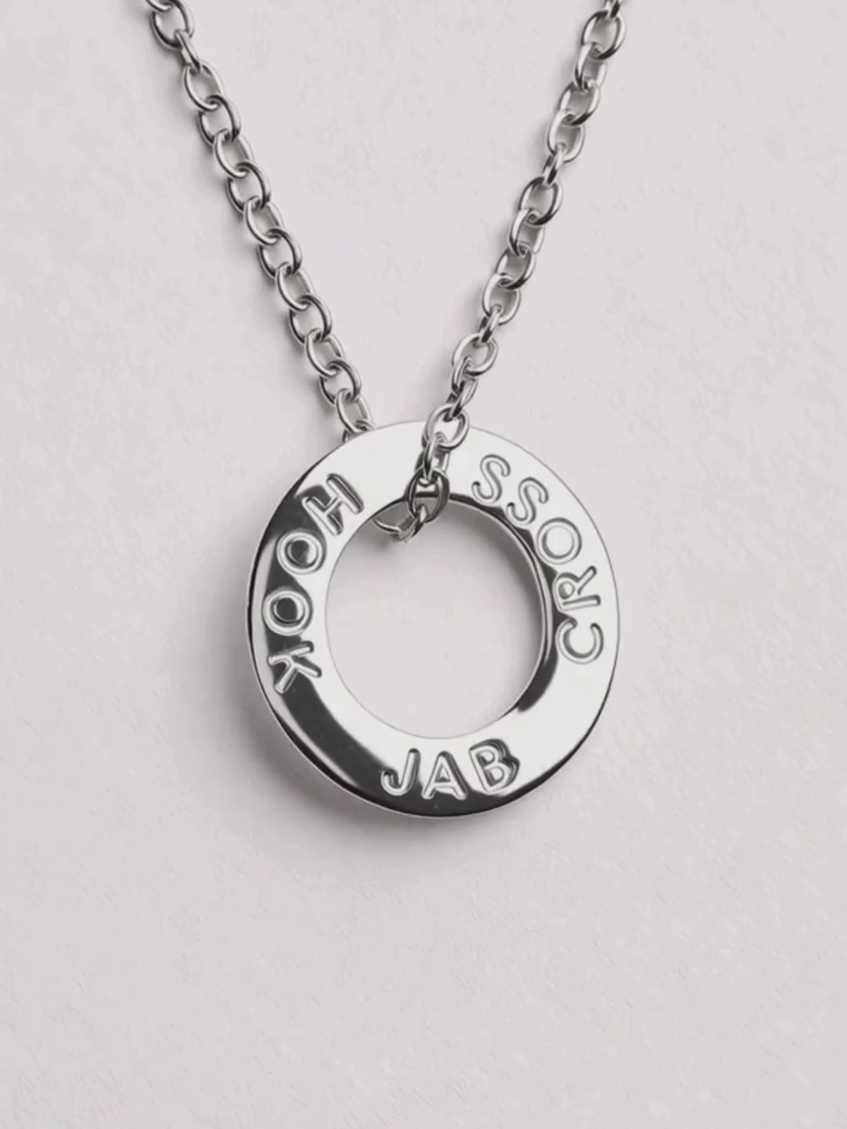 Video close-up of the silver Hera Jab Cross Hook pendant